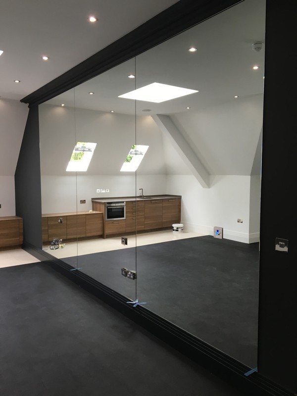 Frameless glass partition in loft conversion by Whitechapel glaziers