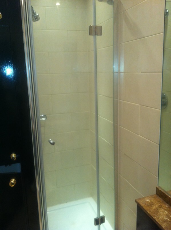 Frameless glass shower enclosure with chrome fittings in Whitechapel