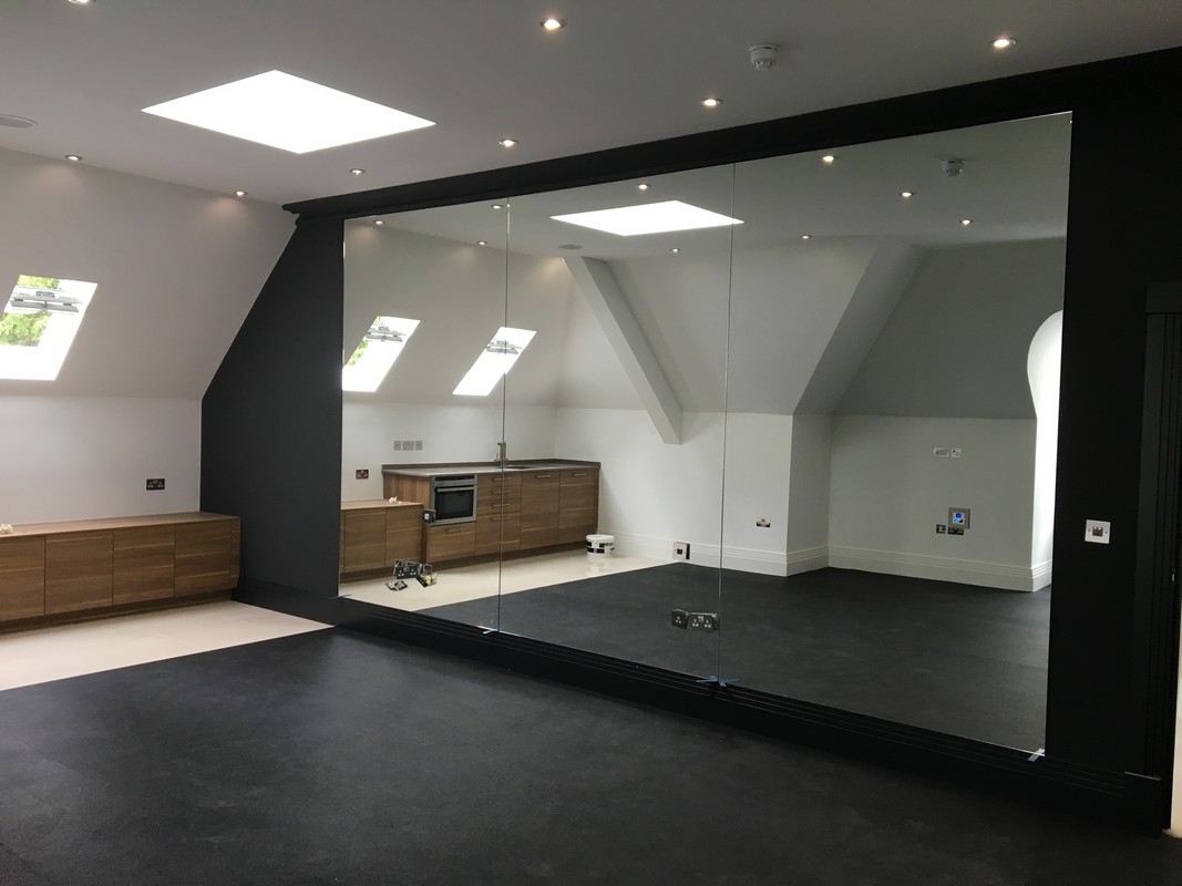 Frameless glass wall dividing loft conversion in Whitechapel